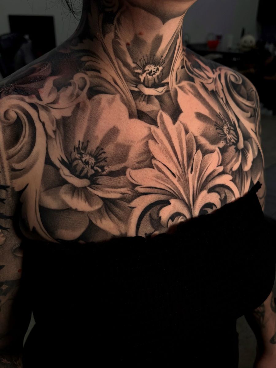 Healed black-and-grey floral chest and neck piece