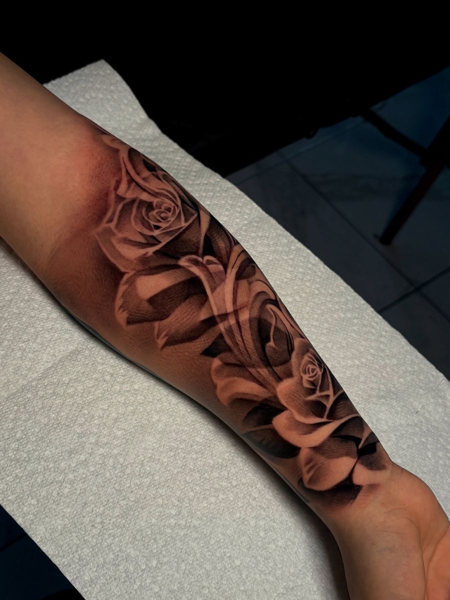 Black-and-grey roses forearm tattoo